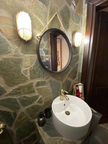 a bathroom with a sink and a mirror at La casa Varsani in Anilio Metsovo