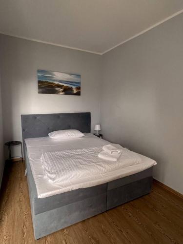a bedroom with a large bed with white sheets at Villa Seebach in Boltenhagen