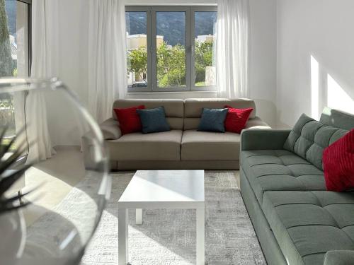 a living room with a couch and a table at Lavander Bay B01 in Donji Morinj