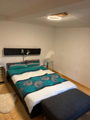 a bedroom with a bed with a green and white blanket at Landhaus inklusive Parkplatz in Schotten