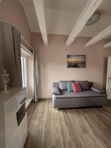 a living room with a couch and a window at Villa Seebach in Boltenhagen