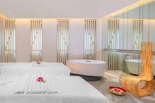 um quarto com 2 camas e uma banheira em Le Meridien Mahabaleshwar Resort & Spa em Mahabaleshwar