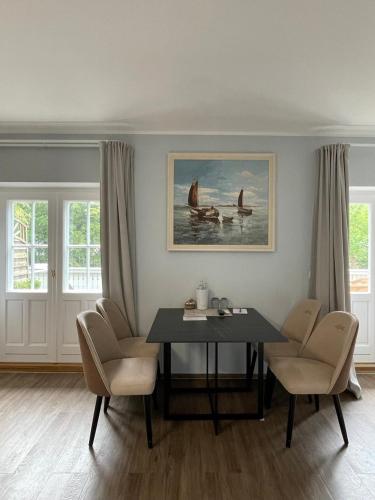 a dining room with a table and chairs at Villa Seebach in Boltenhagen
