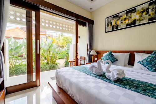 a bedroom with a large bed with swans on it at sayana bali in Gianyar
