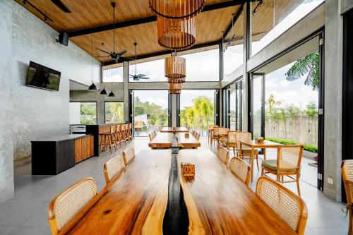 a large dining room with a wooden table and chairs at sayana bali in Gianyar