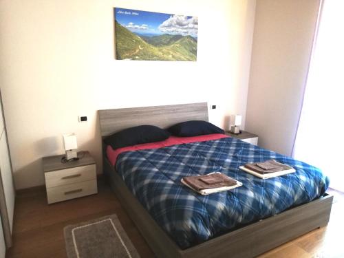 a bedroom with a bed with two towels on it at Ai piedi del Monte Cimone in Fiumalbo