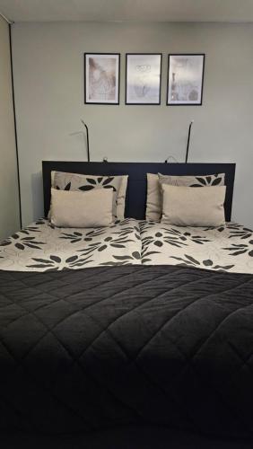 a bedroom with a black and white bed with two pillows at Separate floor of a house in Arvidsjaur