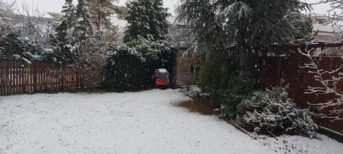 a snow covered yard with a fence and a fire hydrant at Villa SCS Nähe in Wiener Neudorf