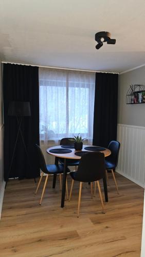 a dining room with two tables and chairs and a window at Separate floor of a house in Arvidsjaur