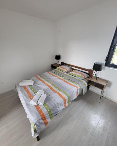 a bedroom with a bed with a colorful comforter at Duos West in Soko Banja