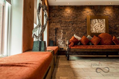 a room with two beds and a brick wall at Infinity PartyPadsLiverpool Hen and Stag Welcome in Liverpool
