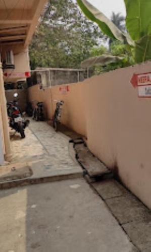 an alley with a fence and a wall at Meera Guest House,Cuttack in Cuttack