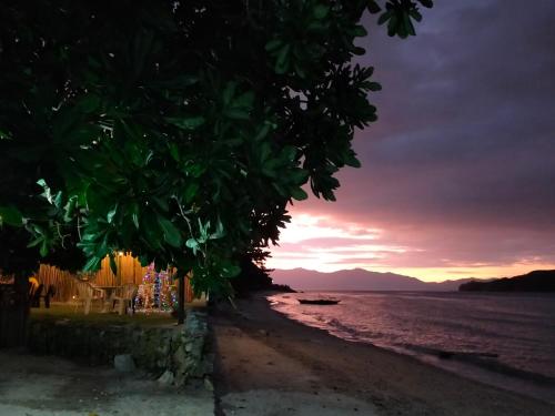 a view of the beach at sunset at Sea u inn in Romblon