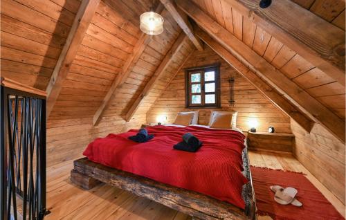 a bedroom with a red bed in a log cabin at Awesome Home In Gorkovec With Outdoor Swimming Pool in Letovčan Tomaševečki