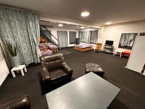 a living room with a couch chair and a table at Penzion Roko in Rokytnice nad Jizerou