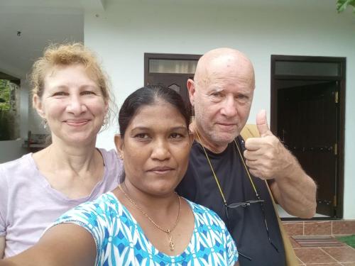 a man and a woman giving a thumbs up at Little Villa Guest House in Ahangama