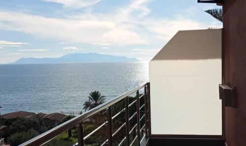 a view of the ocean from a balcony at Spiros Rooms in Kastrosikia