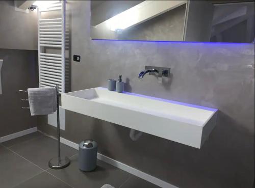a bathroom with a white sink and a mirror at Villa Primodì in Bologna