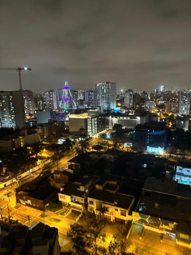 a city lit up at night with at Departamento Exclusivo clase A in Lima