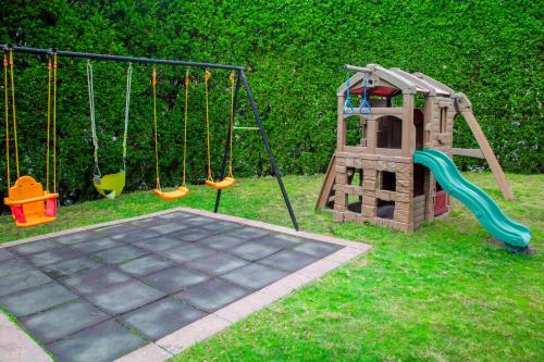 a playground with a slide and a swing at City Tower Hotel in Kuwait