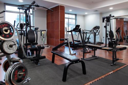 a gym with several treadmills and weights at City Tower Hotel in Kuwait