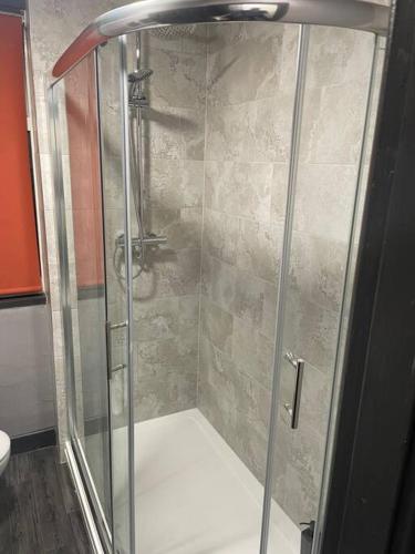 a shower with a glass door in a bathroom at 1 Bed Apartment Sleeps 3, Ferryhill Near Durham & WiFi in Ferryhill