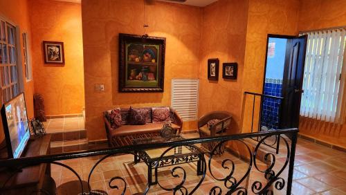 a living room with a couch in a room at Casa Colonial Estate, Cozumel in Cozumel