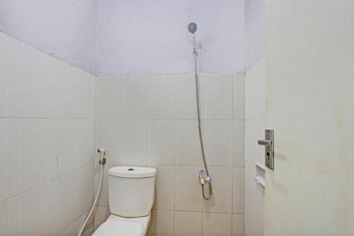 a bathroom with a shower with a toilet at OYO 93208 Guest House Cemara 2 in Brebes