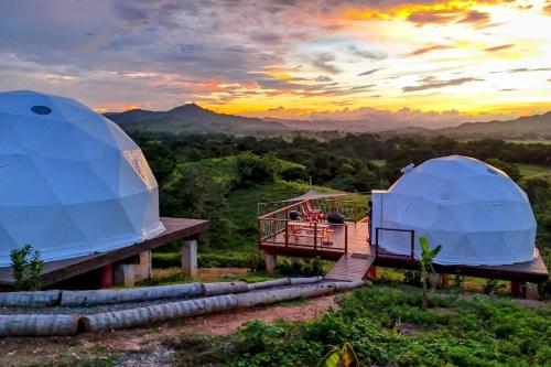 two domes and a deck with a view of the mountains at Domescape Glamping in El Cedro