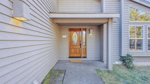 a house with a wooden door on the side of it at Big Leaf - Unit 6 in Sunriver