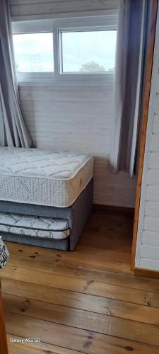a bedroom with two mattresses in front of a window at Shiatsu Rocha in Montevideo