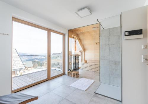 a bathroom with a shower and a large window at 1A Chalet 'Horst' Wandern, Grillen, Panorama Sauna! in Klippitztorl