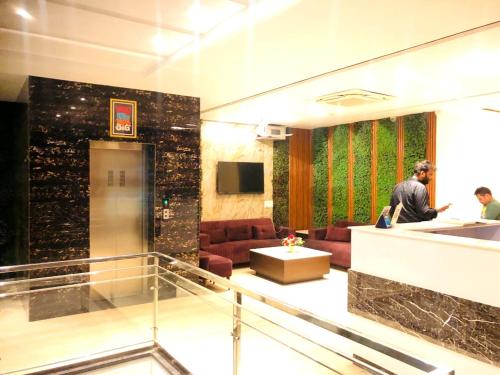 a lobby with two people sitting in a room at kd residency in Zirakpur
