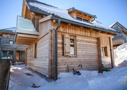 a wooden house in the snow with snow around it at 1A Chalet 'Horst' Wandern, Grillen, Panorama Sauna! in Klippitztorl