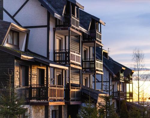 a building with balconies on the side of it at JollyKop Apartments in Kopaonik