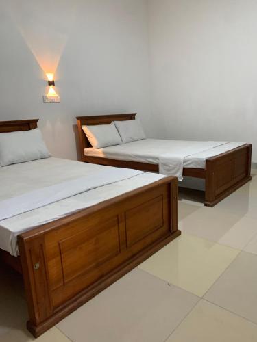 two beds sitting next to each other in a room at Bethany Homestay in Katunayaka