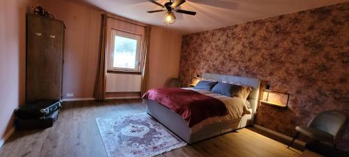 a bedroom with a bed and a ceiling fan at Gárdonyi Ház in Sály
