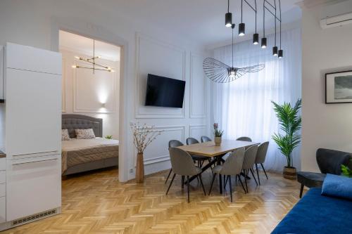 ein Esszimmer und ein Wohnzimmer mit einem Tisch und Stühlen in der Unterkunft Luxurious Central 4BEDRM 3BATHRM Residence w/ Balcony in Budapest