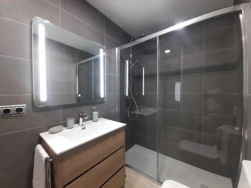 a bathroom with a sink and a shower at KAIOA .Incluye parking privado. in Hondarribia