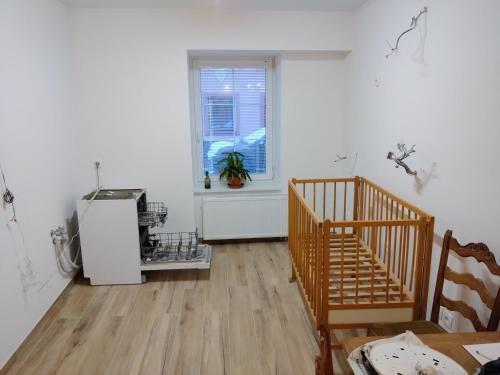 an empty room with a refrigerator and a window at Apartmány u Martina in Javorník