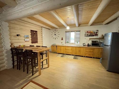a large kitchen with a table and a refrigerator at Horizon Apartmens in Yablunytsya