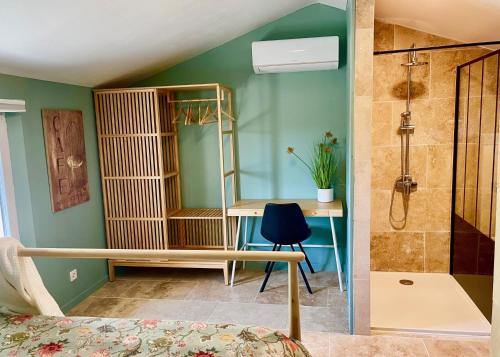 a bedroom with a shower and a desk with a mirror at La Belle Lumière in Saint-Saturnin-lès-Apt