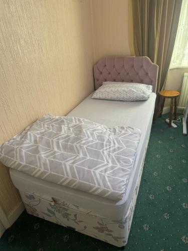 a pair of twin beds in a room at Double room in Canvey