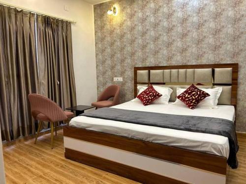a bedroom with a large bed with red pillows at Apartment in Varanasi (1BHK) in Pura Raghunāth