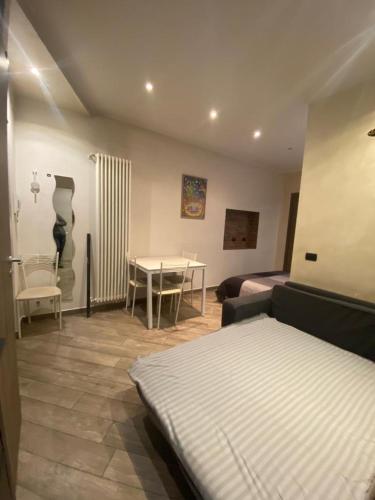 a bedroom with a bed and a table and a couch at Mia Monza Suite in Monza