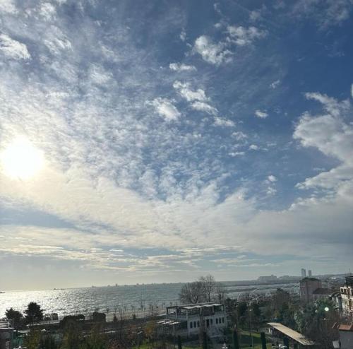 a cloudy sky over the water and a city at Sareban Hotel Istanbul in Istanbul