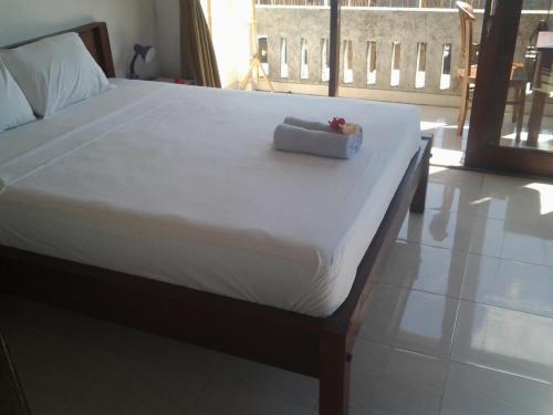 a bed with a box on top of it at Sony Home Stay in Amed