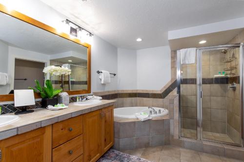 a bathroom with a tub and a sink and a shower at Town Pointe A105 in Park City