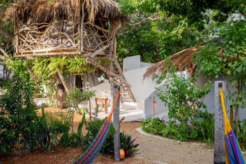 a resort with a hammock in front of a building at Bahaka Jeri in Jericoacoara