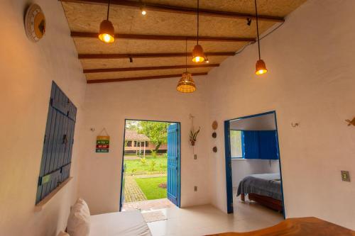 a bedroom with a bed and a door to a yard at CasaPEDROCasaMarcio - Soure, Marajó PA in Soure